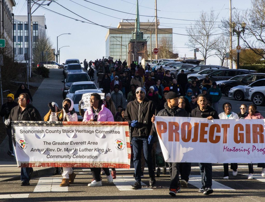 People walk down Wall Street in Everett during the Snohomish County Black Heritage Committees annual Martin Luther King Jr. Day march on Monday, Jan. 15, 2024 in Everett, Washington. (Olivia Vanni / The Herald)