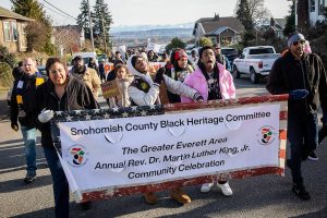Noah Jackson, right, and Daniel “Prince” Cacho, left, sing while they lead a group of approximately 100 people Monday in a Martin Luther King Jr. Day march in Everett, Washington. (Olivia Vanni / The Herald)