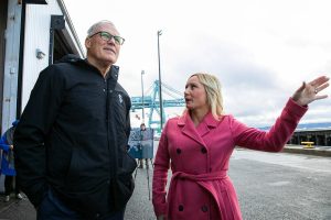 Gov. Jay Inslee and Port of Everett CEO Lisa Lefeber take a look at Pier 3 while discussing future plans for the Port of Everett Seaport on Wednesday, Jan. 17, 2024, in Everett, Washington. The Port is raising funds to renovate Pier 3 and make it capable of charging electric vessels. (Ryan Berry / The Herald)