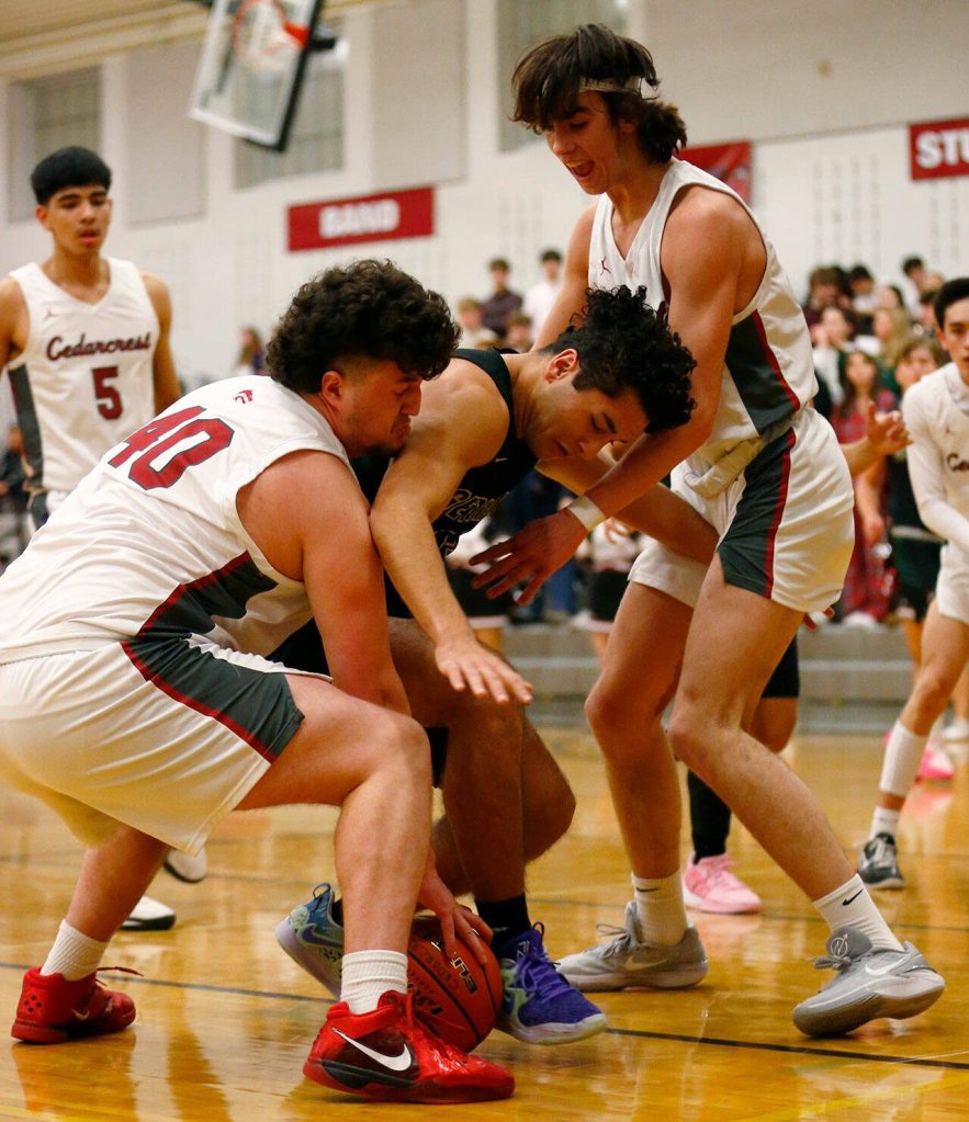 Cedarcrests defense forces a turnover against Marysville Getchell on Tuesday, Jan. 16, 2024, at Cedarcrest High School in Duvall, Washington. (Ryan Berry / The Herald)