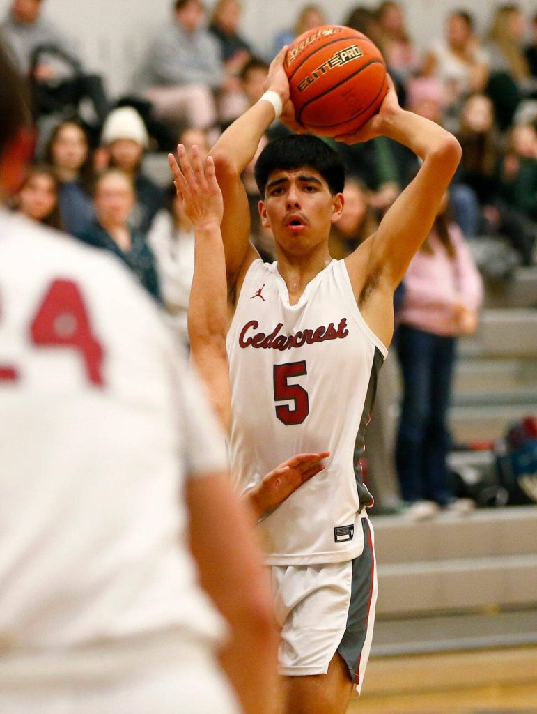 Cedarcrests Alex Amaral looks to pass out of the lane against Marysville Getchell on Tuesday, Jan. 16, 2024, at Cedarcrest High School in Duvall, Washington. (Ryan Berry / The Herald)