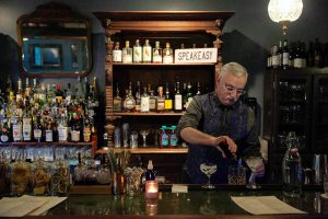 Bartender Kevin Taylor throws together a few drinks while working behind the bar at The Colby Club on Monday, Jan. 15, 2024, in Everett, Washington. (Ryan Berry / The Herald)