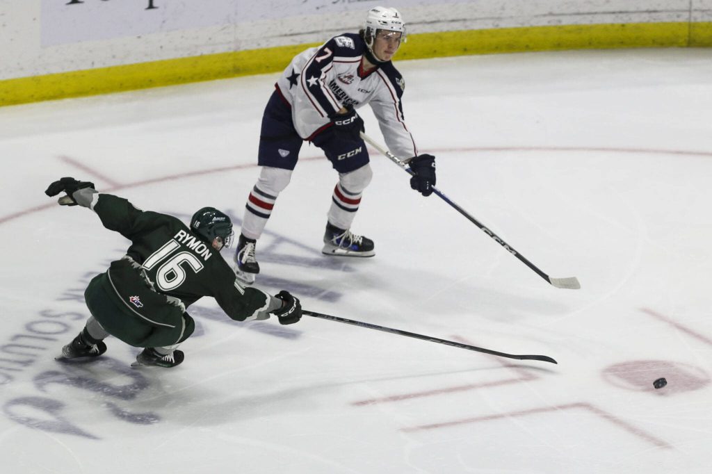 Silvertips Dominik Rymon (16) fights for the puck during a game between the Everett Silvertips and Tri-City Americans at the Angel of the Winds Arena on Sunday, Jan. 21, 2024. The Silvertips won, 5-3. (Annie Barker / The Herald)