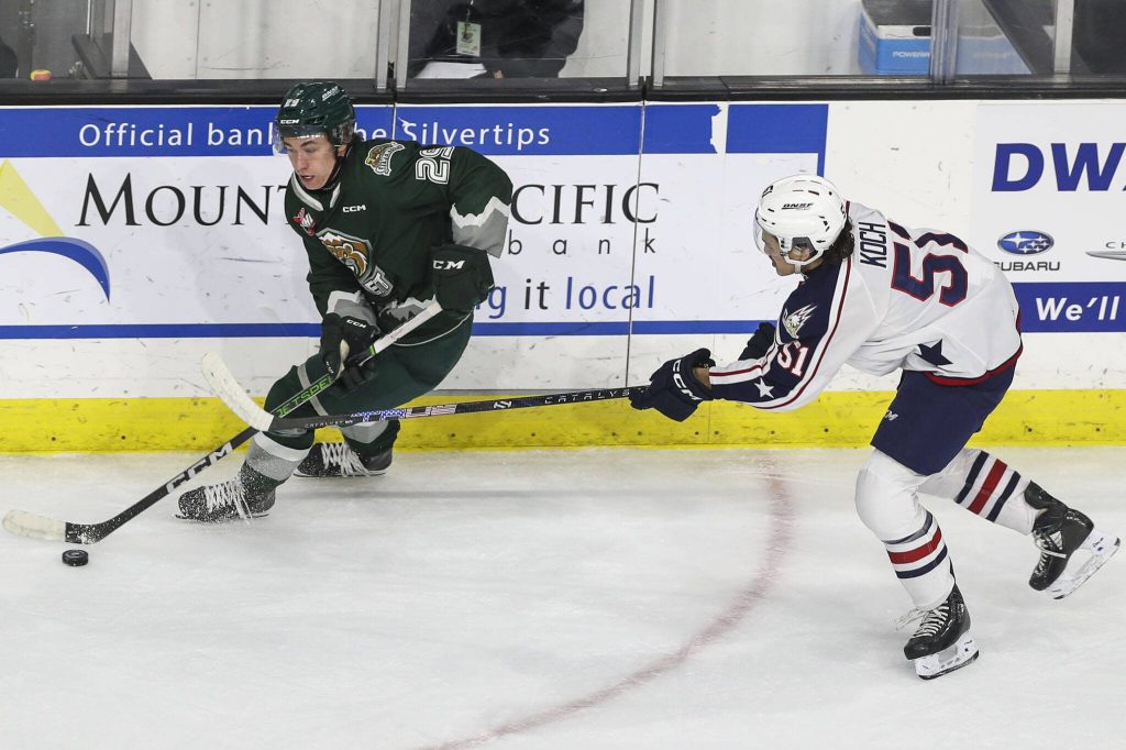 Silvertips Teague Patton (29) fights for the puck during a game against the Tri-City Americans on Sunday at the Angel of the Winds Arena in Everett. (Annie Barker / The Herald)