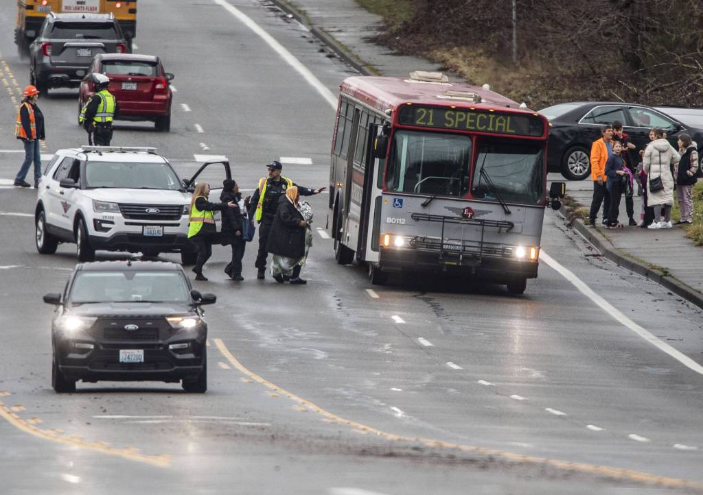 Fleeing people board an Everett Transit bus on Wednesday, Jan. 31, 2024 in Everett, Washington. (Olivia Vanni / The Herald)