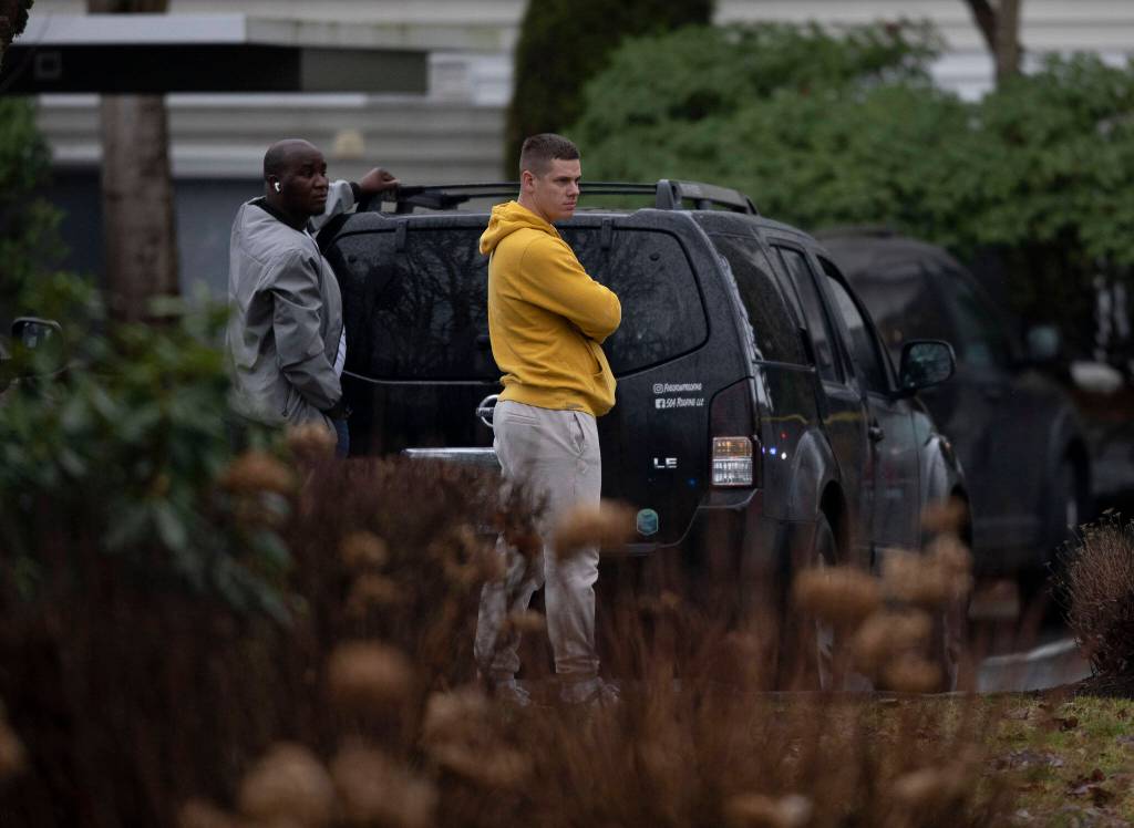 Bystanders watch police movement along 112th Street SW on Wednesday, Jan. 31, 2024 in Everett, Washington. (Olivia Vanni / The Herald)