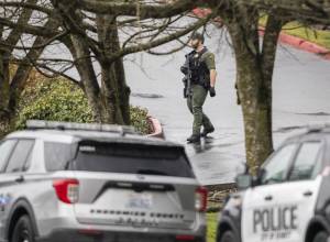 A Snohomish County sheriffs deputy walks down a hill toward 112th Street SW on Wednesday, Jan. 31, 2024 in Everett, Washington. (Olivia Vanni / The Herald)