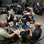 Law enforcement officers, firefighters and medics from Snohomish, King and Pierce counties use computers to simulate an active shooter scenario in a ballroom at Angel of the Winds Arena on Wednesday, June 13, 2018 in Everett, Wa. (Andy Bronson / The Herald)