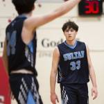 Toby Trichler, left, directs brother Eli Trichler, right, during the game against Kings on Jan. 23 in Shoreline. (Olivia Vanni / The Herald)