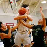 Marysville Getchells Ano Palacol, left, and Bubba Palacol, right, work together to knock free a loose ball against Cedarcrest on Jan. 16 at Cedarcrest High School in Duvall. (Ryan Berry / The Herald)