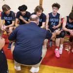 Toby Trichler high-fives his dad and coach Nate Trichler during a timeout on Jan. 23 in Shoreline. (Olivia Vanni / The Herald)