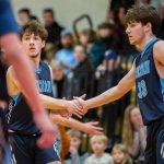 Toby Trichler, left, and brother Eli Trichler, right, high five after a blocked shot during the game against King's on Tuesday, Jan. 23, 2024 in Shoreline, Washington. (Olivia Vanni / The Herald)
