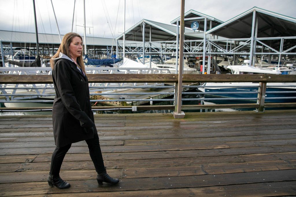 Angela Harris, Executive Director of the Port of Edmonds, walks along the ports old boardwalk Wednesday, Jan. 24, 2024, in Edmonds, Washington. (Ryan Berry / The Herald)