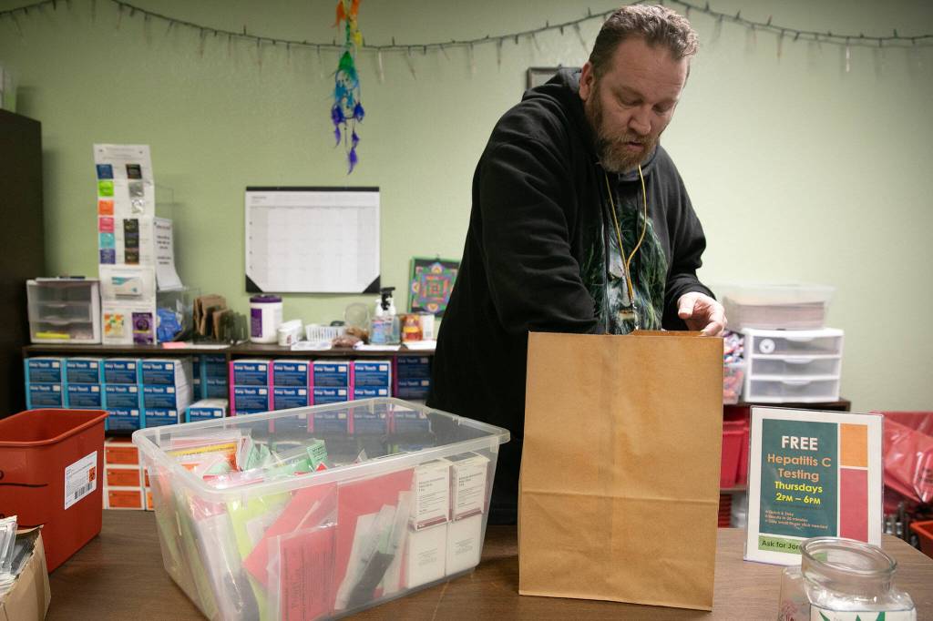 Joe Dugan, HRC Community Outreach Specialist, packs a bag with Naloxone and other supplies on Thursday, Jan. 25, 2024, at the Sound Pathways Harm Reduction Center in Everett, Washington. (Ryan Berry / The Herald)