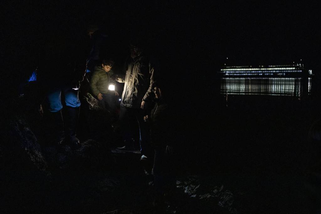 People look for ocean creatures during the Starlight Beach Walk on Tuesday, Feb. 6, 2024 near the Olympic Beach Visitor Station in Edmonds, Washington. (Annie Barker / The Herald)