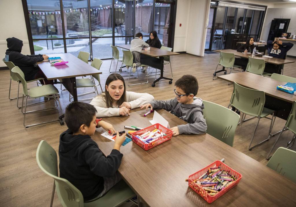 Mariella Brock talks with brothers Juakin and Gael Hernandez during a new free after-school program at Connect Casino Road on Monday, Jan. 29, 2024 in Everett, Washington. (Olivia Vanni / The Herald)
