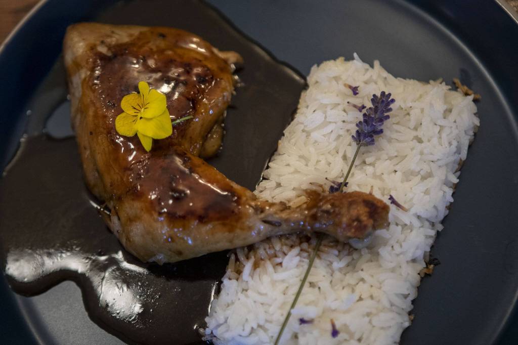 A Coq Au Rhum dish with roasted chicken, lavender rice and pineapple-rum sauce at the Bush House Inn in Index. (Annie Barker / The Herald)