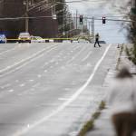 A police officer walks across 112th Street SW with police tape on Wednesday, Jan. 31, 2024 in Everett, Washington. (Olivia Vanni / The Herald)