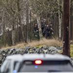 Police officers break a hole in a fence along 112th Street SW on Wednesday, Jan. 31, 2024 in Everett, Washington. (Olivia Vanni / The Herald)