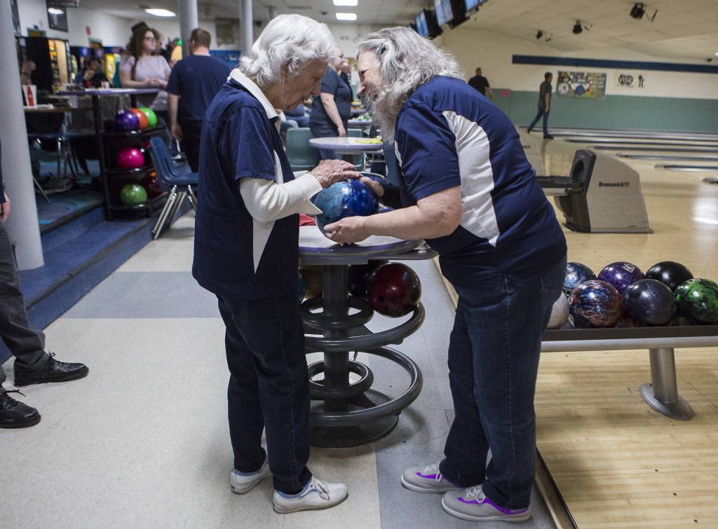 Carol Perry high fives her daughter Kathy Larsen before her turn to bowl during league bowling at Strawberry Lanes on Wednesday, Feb. 26, 2020 in Marysville , Wa. (Olivia Vanni / The Herald)