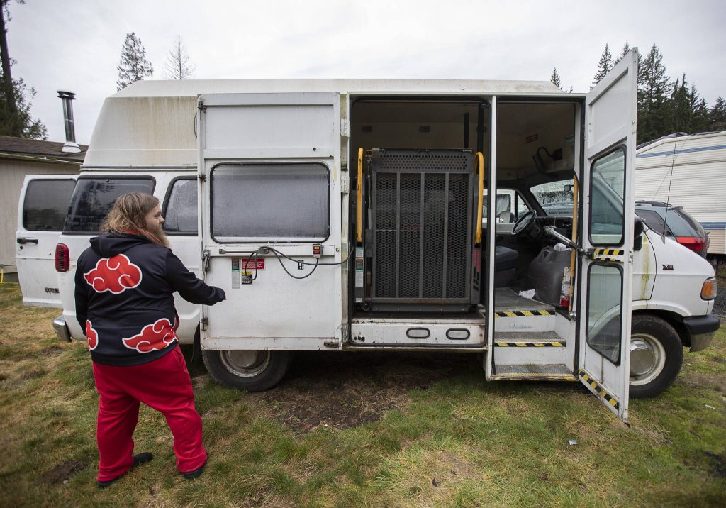 Johnson De Vor walks around the lift side of the van on Monday, Feb. 5, 2024 in Granite Falls, Washington. (Olivia Vanni / The Herald)