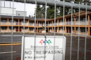 A Snohomish County no trespassing sign hangs on a fence surrounding the Days Inn on Monday, Feb. 12, 2024 in Everett, Washington. (Olivia Vanni / The Herald)