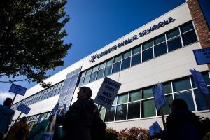Everett Public Schools paraeducators protest outside of the Everett School Board meeting on Tuesday, Oct. 10, 2023 in Everett, Washington. (Olivia Vanni / The Herald)