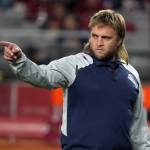 New England Patriots linebacker coach Steve Belichick warms up before a game against the Arizona Cardinals on Dec. 12, 2022, in Glendale, Ariz. Belichick has agreed to be the defensive coordinator for new coach Jedd Fisch at Washington, a person with knowledge of the move told The Associated Press on Monday. (AP Photo/Rick Scuteri, FIle)