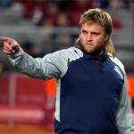 FILE - New England Patriots linebacker coach Steve Belichick warms up before an NFL football game against the Arizona Cardinals, Monday, Dec. 12, 2022, in Glendale, Ariz. Steve Belichick has agreed to be the defensive coordinator for new coach Jedd Fisch at Washington, a person with knowledge of the move told The Associated Press on Monday, Feb. 5, 2024. The son of NFL coaching great Bill Belichick will take a role in college for the first time following 12 seasons working on the staff of the New England Patriots with his dad. (AP Photo/Rick Scuteri, FIle)