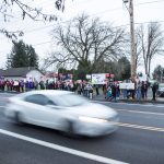 A car drives by a rally outside of the Marysville School Board on Monday, Feb. 5, 2024 in Marysville, Washington. (Olivia Vanni / The Herald)