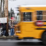 A school bus drives by rally before a Marysville School Board meeting on Monday, Feb. 5, 2024 in Marysville, Washington. (Olivia Vanni / The Herald)