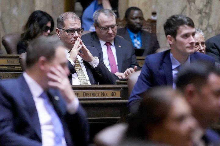 Rep. Strom Peterson, D-Edmonds, watches the State of the State speech by Gov. Jay Inslee on Jan. 9, the second day of the legislative session, at the Washington state Capitol in Olympia, Wash. (AP Photo/Lindsey Wasson)