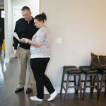 As a home inspector looks over a house they intend to buy, Heather and Tyler Ferrel look over paperwork about the house on Wednesday, Nov. 28, 2018 in Marysville, Wa. (Andy Bronson / The Herald)