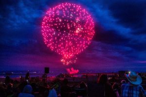 People gather to watch the Thunder on the Bay Fireworks from Legion Memorial Park on Wednesday, July 4, 2018 in Everett, Wa. (Olivia Vanni / The Herald)