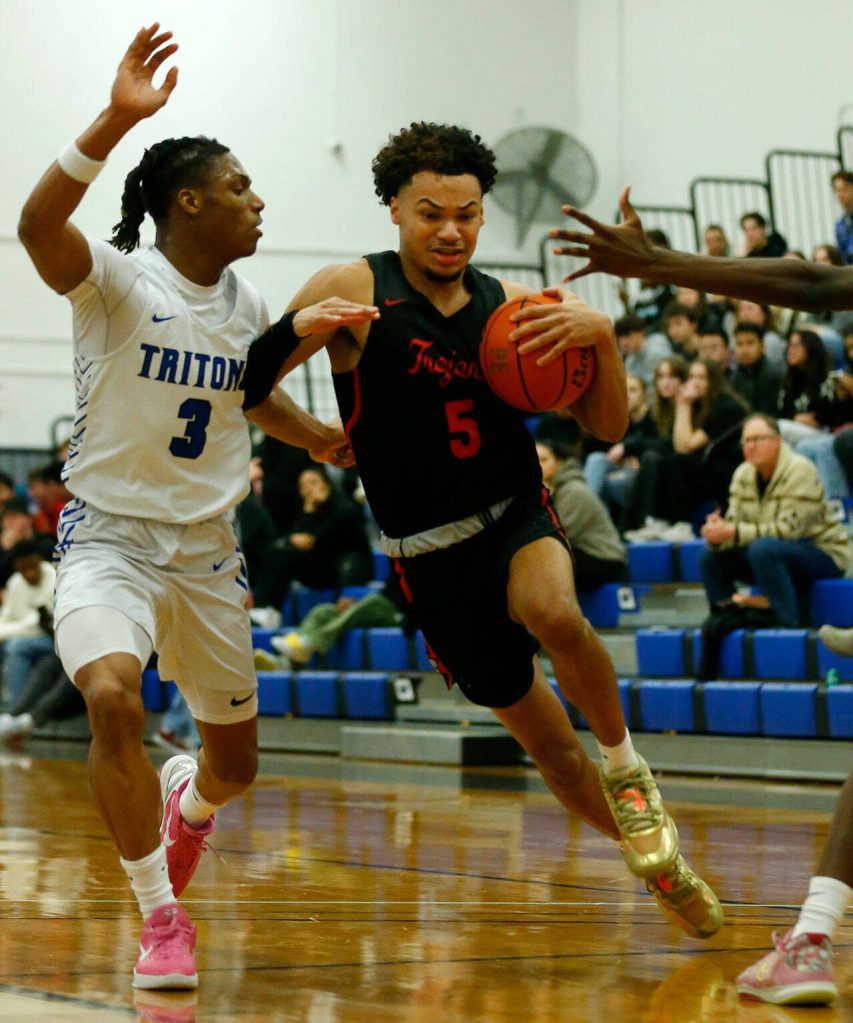 Everett Community Colleges Daniel Headdings splits two defenders on his way to the lane against Edmonds College on Wednesday, Feb. 7, 2024, at Seaview Gym in Lynnwood, Washington. (Ryan Berry / The Herald)