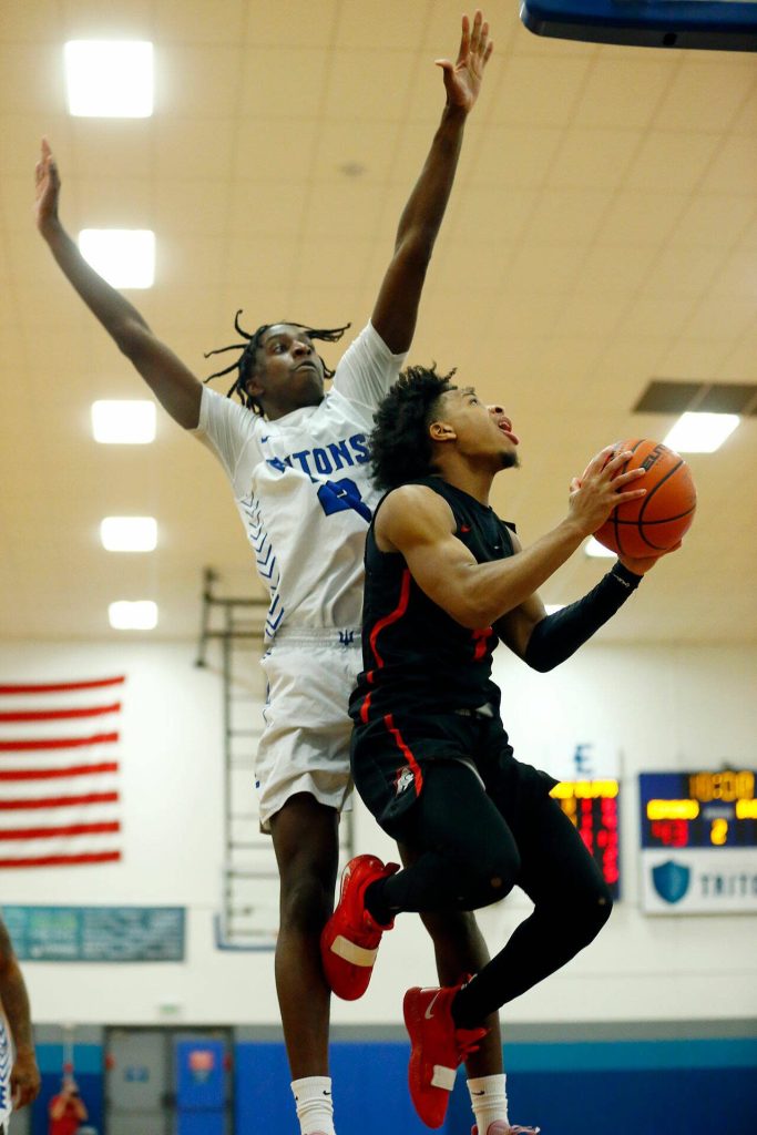 Edmonds Colleges Josiah Pierre goes up before recording a block against Everett Community College on Wednesday, Feb. 7, 2024, at Seaview Gym in Lynnwood, Washington. (Ryan Berry / The Herald)