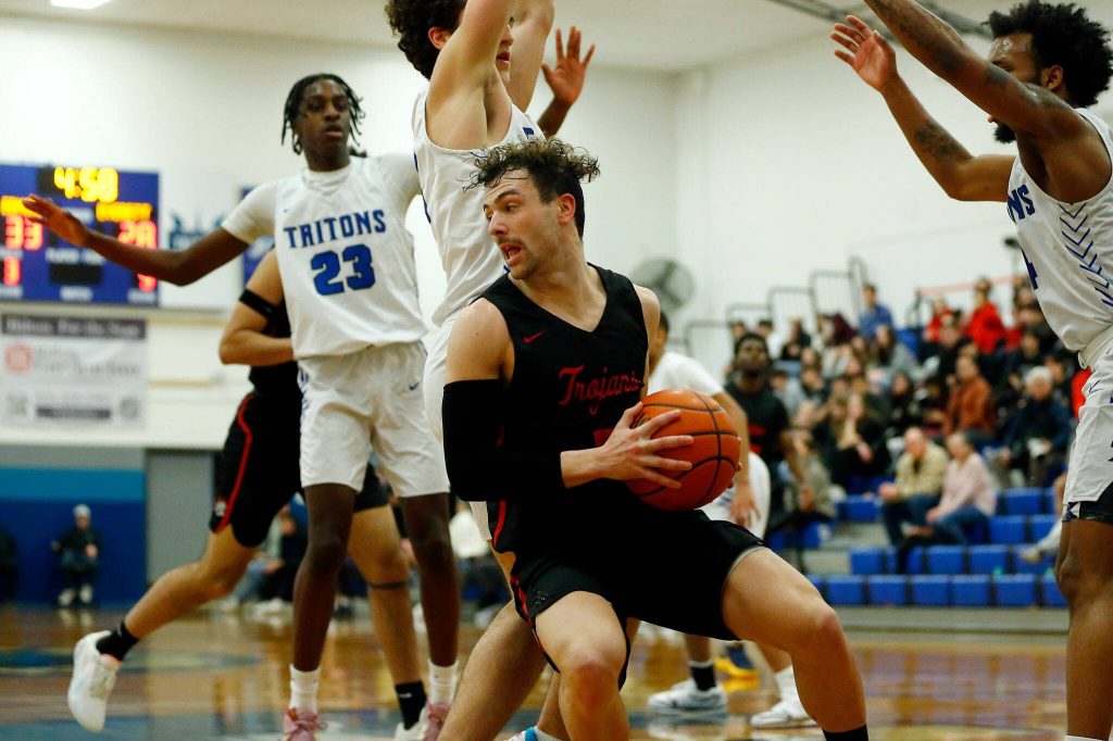 Everett Community Colleges Derek Smith tries to spin out of trouble in the lane against Edmonds College on Wednesday, Feb. 7, 2024, at Seaview Gym in Lynnwood, Washington. (Ryan Berry / The Herald)