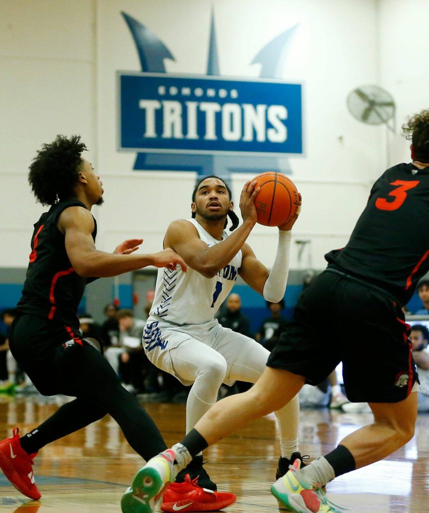 Edmonds Colleges Chris Lee head fakes a shot against Everett Community College on Wednesday, Feb. 7, 2024, at Seaview Gym in Lynnwood, Washington. (Ryan Berry / The Herald)