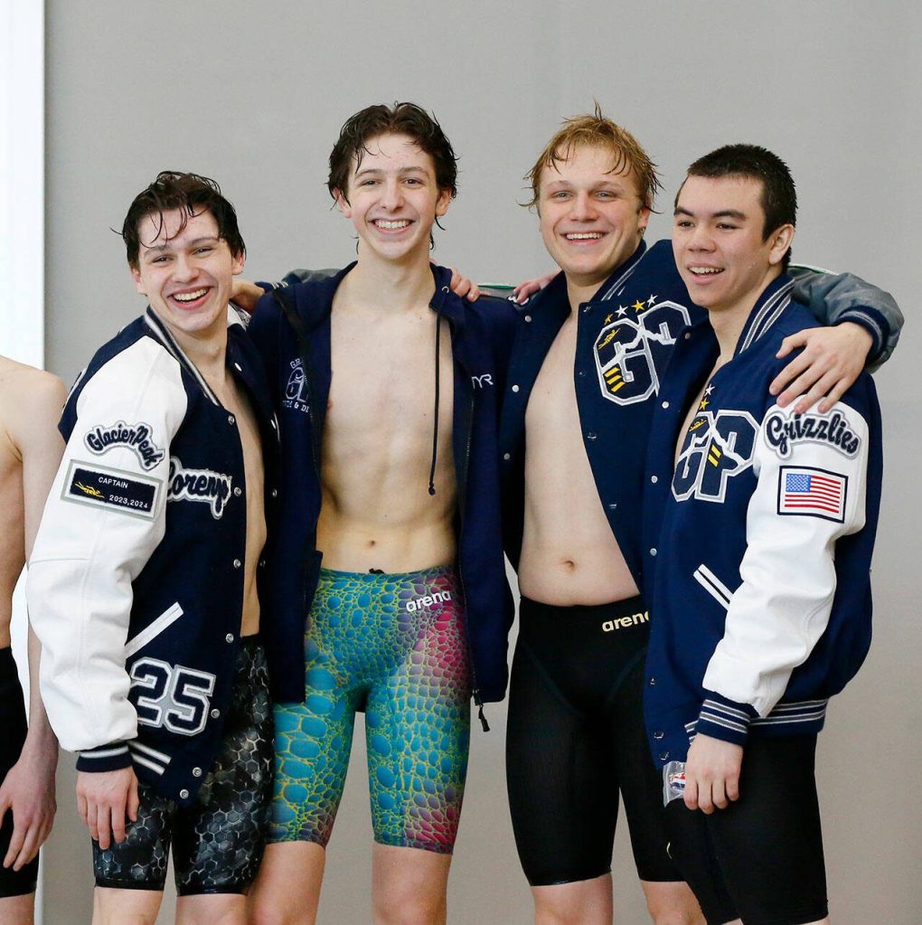 The Glacier Peak boys celebrate a victory in the 400-yard freestyle relay during the Class 4A District 1 swim and dive championships Saturday at the Snohomish Aquatic Center in Snohomish. (Ryan Berry / The Herald)