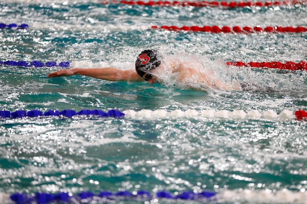 Snohomish junior Torsten Hokanson swims his way to a school and district record in the 100 yard freestyle with a time of 46.45 seconds during the Class 3A District 1 swim and dive meet Saturday at the Snohomish Aquatic Center in Snohomish. (Ryan Berry / The Herald)