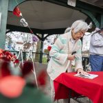 Lyla Anderson and others sign a petition to save the Clark Park gazebo during a heart bomb event hosted by Historic Everett on Saturday, Feb. 17, 2024 in Everett, Washington. (Olivia Vanni / The Herald)