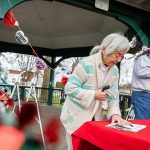 Lyla Anderson and others sign a petition to save the Clark Park gazebo during a “heart bomb” event hosted by Historic Everett on Saturday, Feb. 17, 2024 in Everett, Washington. (Olivia Vanni / The Herald)