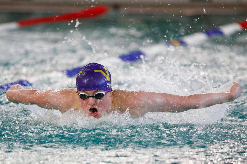 Lake Stevens junior Coren Coe swims in the 100-yard butterfly during the 4A District 1 championship meet Feb. 10 at the Snohomish Aquatic Center in Snohomish. (Ryan Berry / The Herald)