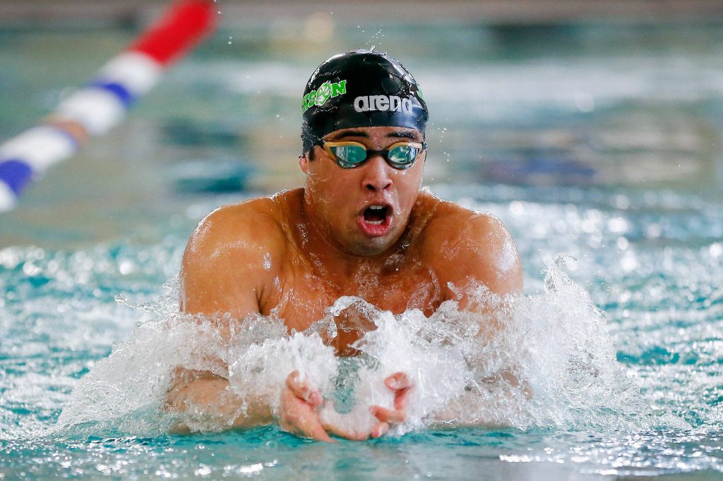Jackson senior Ethan Chen-Parks takes the lead in the 100-yard breaststroke during the 4A District 1 championship meet Feb. 10 at the Snohomish Aquatic Center in Snohomish. (Ryan Berry / The Herald)