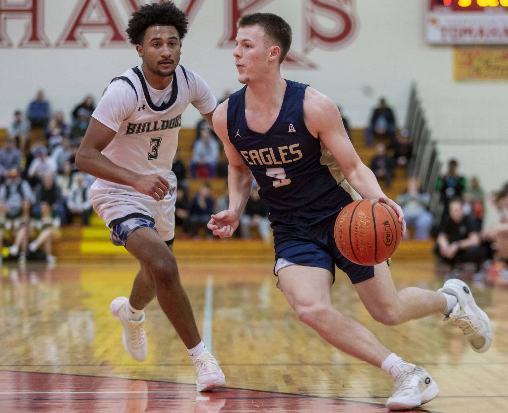 Arlingtons Jackson Trotter drives to the hoop during the game against Mount Vernon on Tuesday, Feb. 13, 2024 in Marysville, Washington. (Olivia Vanni / The Herald)