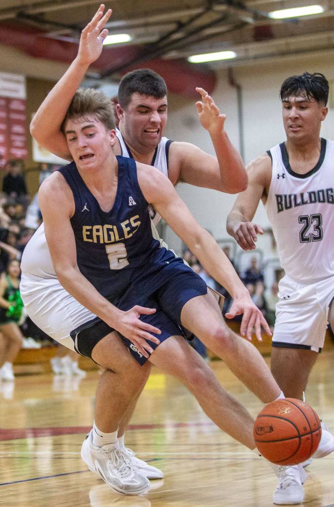 Arlingtons Leyton Martin gets the ball knocked out of his hands and is fouled while driving to the hoop during the game against Mount Vernon on Tuesday, Feb. 13, 2024 in Marysville, Washington. (Olivia Vanni / The Herald)