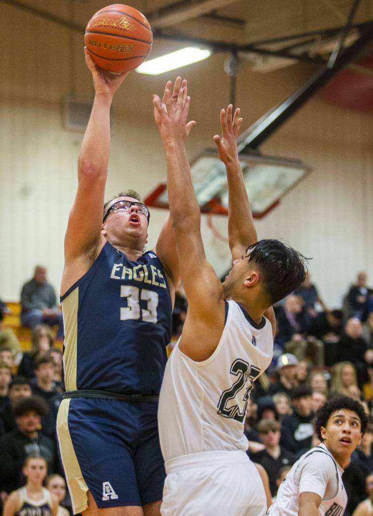 Arlingtons Billy Kooy make a jump shot during the game against Mount Vernon on Tuesday, Feb. 13, 2024 in Marysville, Washington. (Olivia Vanni / The Herald)
