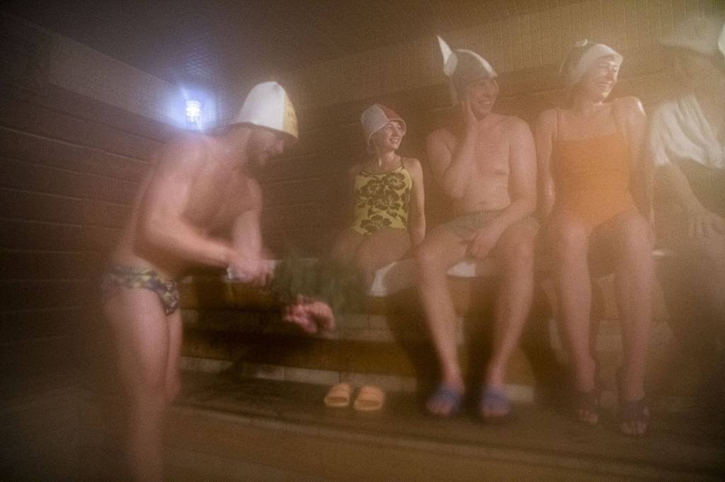 A group of friends hang out in the sauna at Banya, an Eastern European style spa in downtown Everett with a sauna that is hotter than a traditional sauna. The gentle swatting by branches intensifies the body heat to better withstand a plunge into a cold pool. (Olivia Vanni / The Herald)