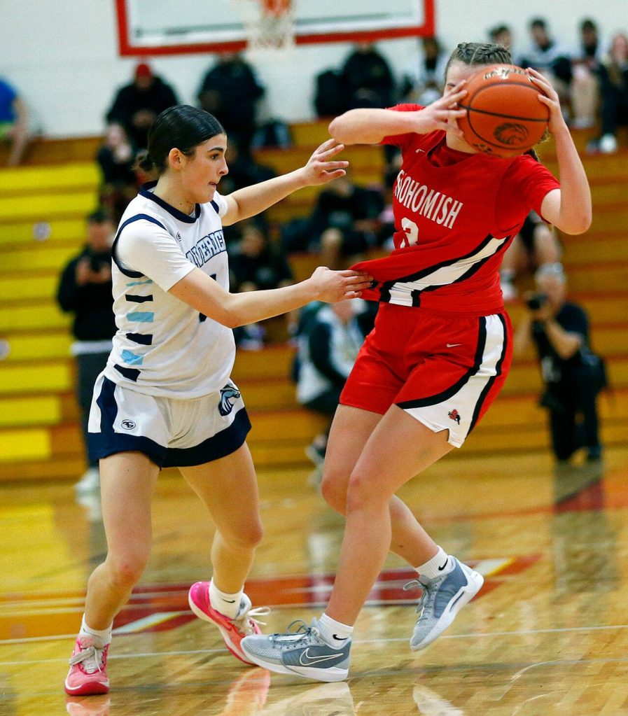 Meadowdales Gia Powell fouls Snohomishs Kendall Hammer during the 3A District One Semifinals on Wednesday, Feb. 14, 2024, at Marysville Pilchuck High School in Marysville, Washington. (Ryan Berry / The Herald)