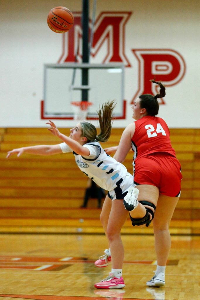 Meadowdales Lexi Zardis and Snohomishs Addyson Gallatin scramble for the ball during the 3A District One Semifinals on Wednesday, Feb. 14, 2024, at Marysville Pilchuck High School in Marysville, Washington. (Ryan Berry / The Herald)
